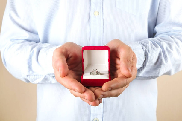 Engagement / marriage / wedding proposal scene. Close up of man handing the expensive gold platinum diamond ring to his bride. - 写真・画像