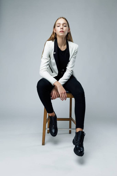 Stylish young woman posing against studio background - Photo, image