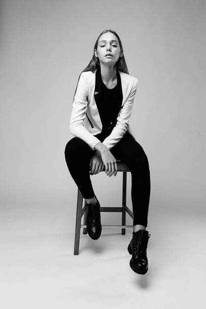 Stylish young woman posing against studio background - Фото, изображение