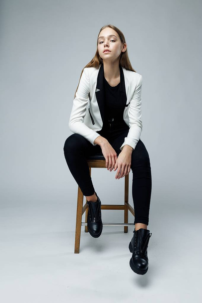 Stylish young woman posing against studio background - Photo, image