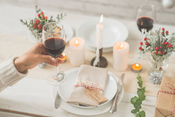 Woman drinking red wine on Christmas eve - Photo, Image