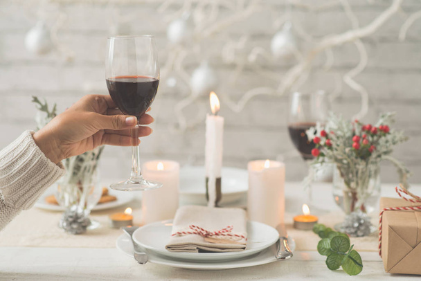 Woman toasting for New Year at dinner table - Photo, Image