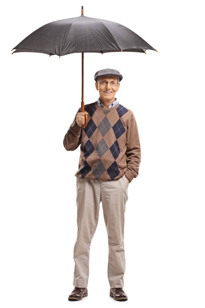 Senior holding an umbrella - Foto, afbeelding