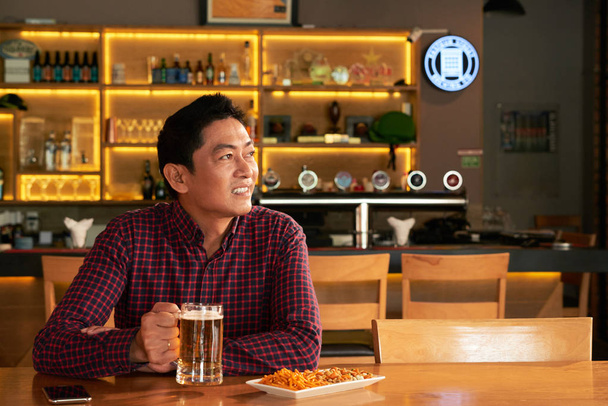 Asiat se těší pivo a občerstvení ve sport baru - Fotografie, Obrázek