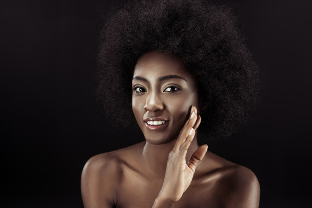 beautiful african american woman touching her face isolated on black - Valokuva, kuva