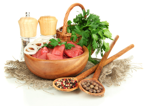 Raw beef meat in bowl with herbs and spices isolated on white - Foto, Imagen