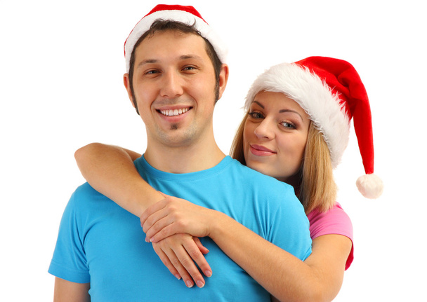 Loving couple in Santa hats isolated on white - Фото, изображение
