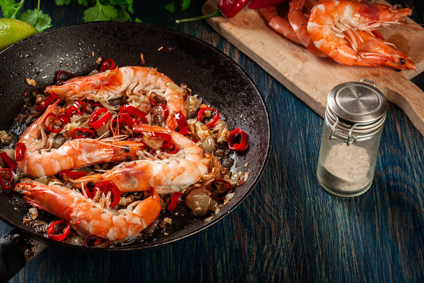 Shrimps roasted on frying pan with onion, garlic and chili - Foto, Bild