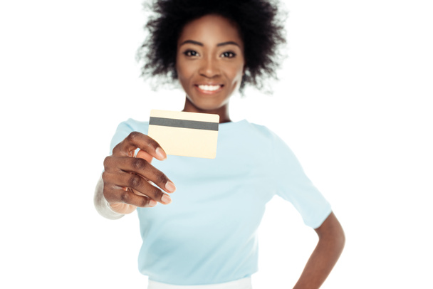 smiling young woman showing credit card at cameraisolated on white - Фото, зображення