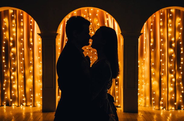 loving couple against the backdrop of lights and arches - Фото, изображение