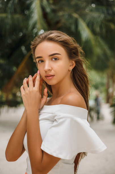 portrait of beautiful young girl posing on sandy beach  - Zdjęcie, obraz