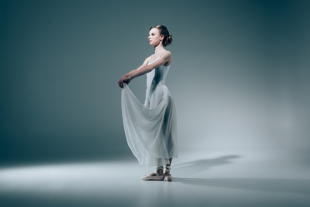 elegant ballerina posing in white dress - Valokuva, kuva