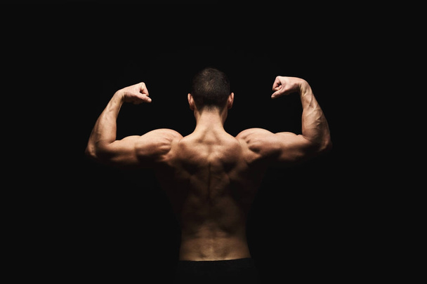 Unrecognizable man shows strong back muscles closeup - Fotografie, Obrázek