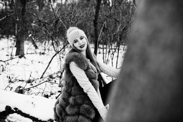 Girl with braces at winter day wear on fur coat and headwear. - Foto, immagini