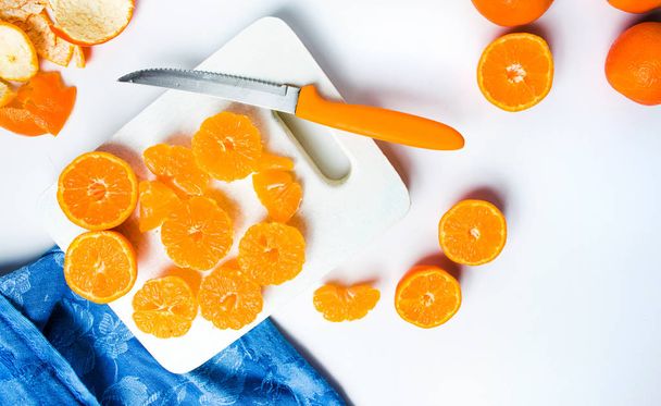 Sliced tangerine on a cutting board - Photo, Image