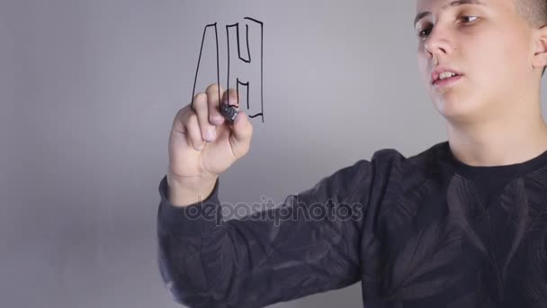 a young man paints on glass whiteboard - Séquence, vidéo