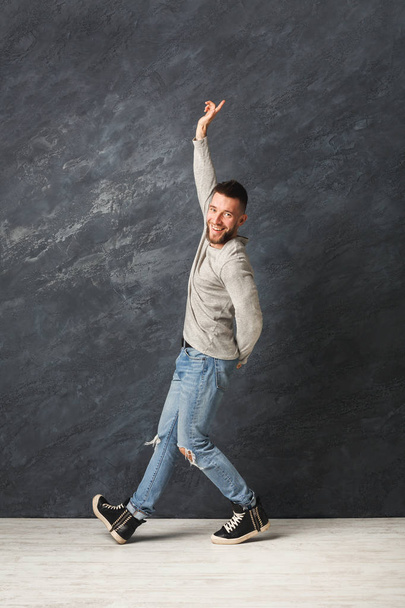 Happy handsome man dancing in studio - Fotoğraf, Görsel
