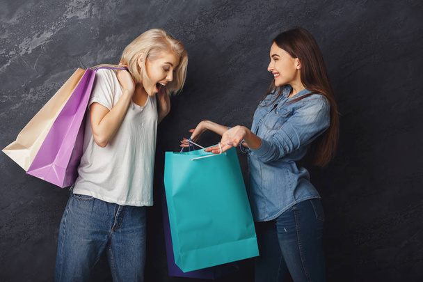 Excited casual girls with shopping bags - Photo, Image