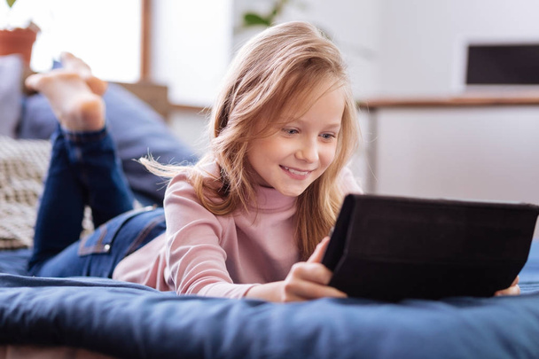 Smiling cute girl using her tablet - Фото, изображение