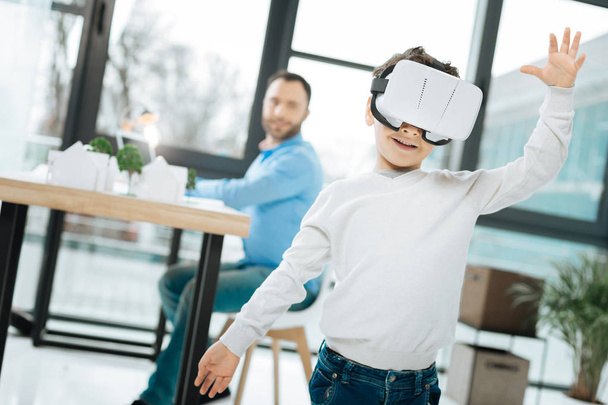 Cheerful little boy testing a new VR headset - 写真・画像