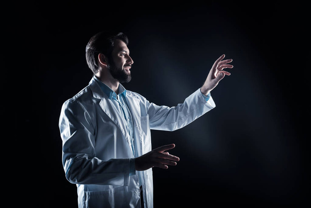 Delighted bearded man wearing a labcoat - Фото, изображение