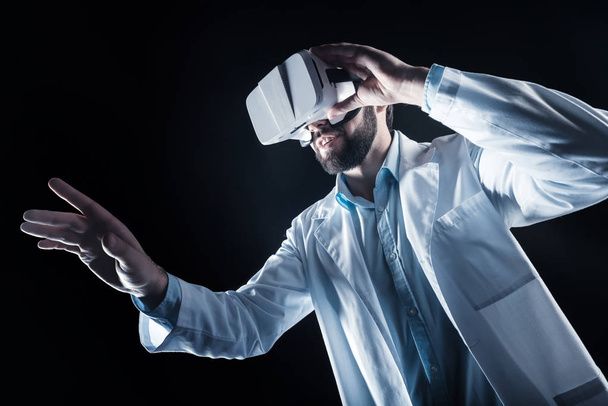 Nice cheerful scientist testing virtual reality glasses - Foto, Bild