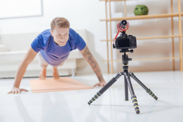 Young trainer being in the process of recording a video lesson - Фото, изображение