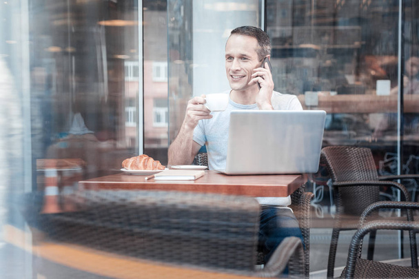 Relaxed male person having coffee break - Photo, Image