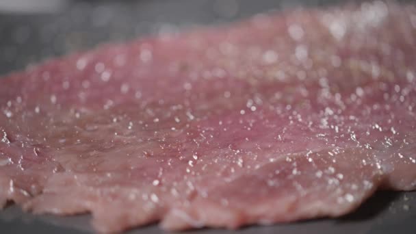 pepper in mill. Wiener schnitzel . Raw pork ready for marinade with oil. Cooking with fire in frying pan. Professional chef in a kitchen of restaurant cooking. - Footage, Video