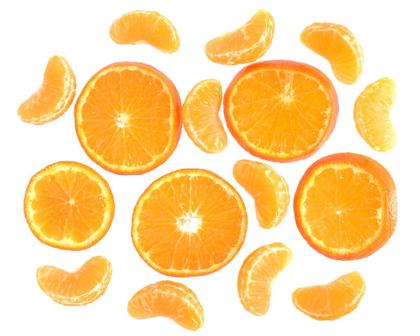 Ripe cut and slice tangerines top view isolated on a white background - 写真・画像