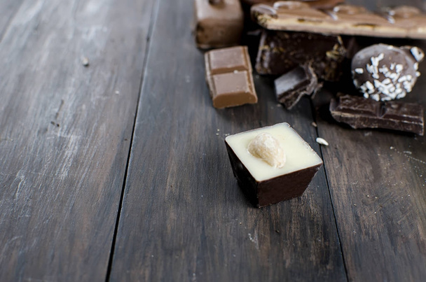 pieces of chocolate on wooden table - Photo, Image