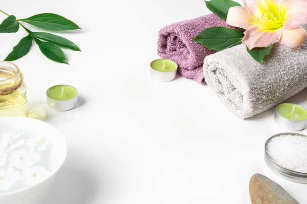 Spa setting of towel, flower isolated on white background with copy space. - Fotó, kép