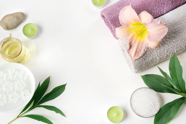 Spa setting of towel, flower isolated on white background with copy space. - Φωτογραφία, εικόνα