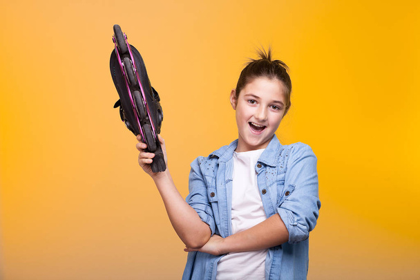 Smilig cute young girl holding a roller in hands - Foto, Imagem