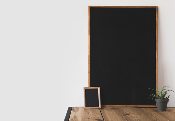 different blackboards and potted plant on wooden table on white  - 写真・画像
