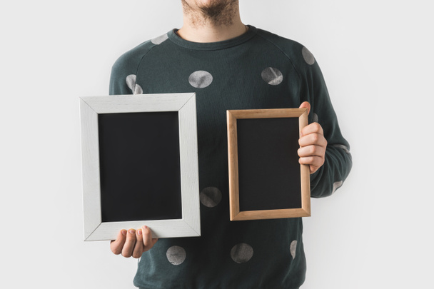 cropped image of man holding empty black boards isolated on white - 写真・画像