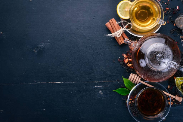 Black and green tea with lemon, honey, cinnamon and ginger. Hot drink Top view. Copy space. - Фото, зображення