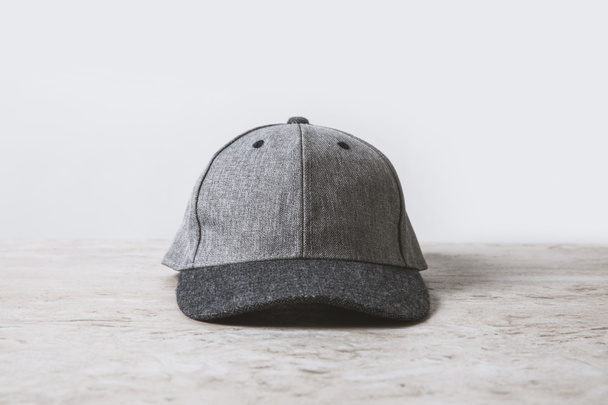 one grey cap on wooden table on white  - Photo, Image