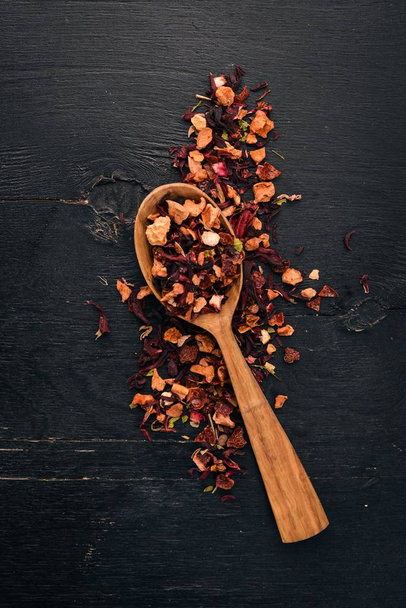 Tea made from dried berries and fruits. On a wooden background. Top view. Copy space. - Фото, зображення