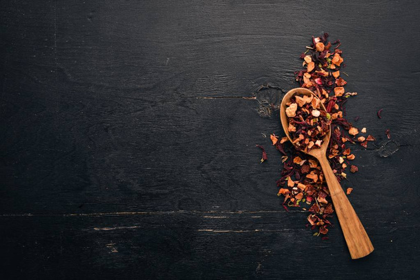 Tea made from dried berries and fruits. On a wooden background. Top view. Copy space. - Φωτογραφία, εικόνα