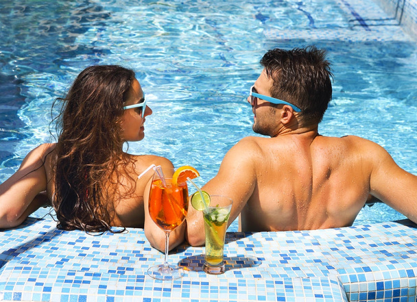 Young couple are relaxing at swimming pool - Fotoğraf, Görsel