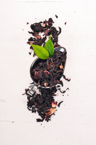 Dry Hibiscus tea. On a wooden background. Top view. Copy space. - Photo, image
