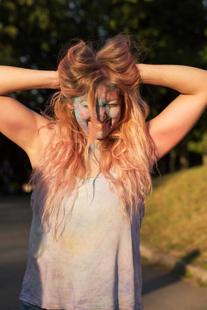 Potěšen blondýnka s dlouhými kudrnatými vlasy pokryté barevné  - Fotografie, Obrázek