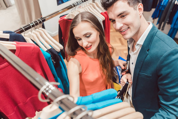 Frau und Mann kaufen Mode in einem Geschäft ein - Foto, Bild