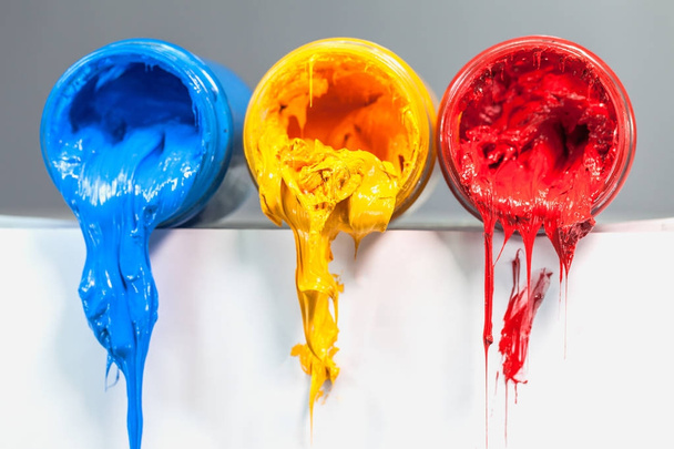 yellow blue and red colors of Plastisol ink on white table. Plastisol ink for print tee shirt and any fabric useful in tee shirt factory. yellow blue and red colors are primary color. - Fotoğraf, Görsel