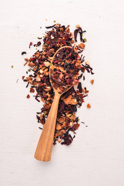 Tea made from dried berries and fruits. On a wooden background. Top view. Copy space. - Photo, image