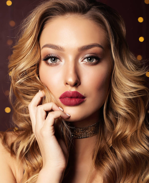 fashion studio portrait of beautiful girl with blond curly hair and evening makeup - Foto, Imagem