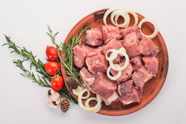 Raw uncooked meat sliced in cubes on wooden rustic background, top view. - Foto, Imagen