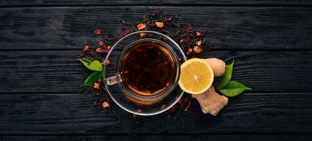 Tea with lemon and ginger. Hot drink On a wooden background. Top view. Copy space. - Fotó, kép