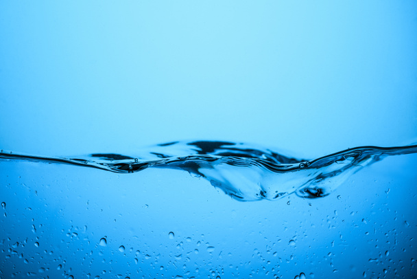 clear water texture with drops, isolated on blue - Photo, Image